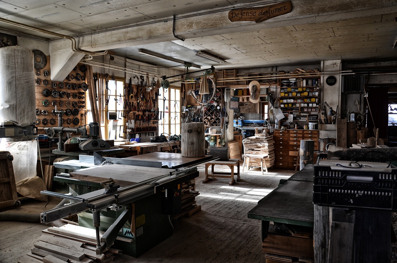 Hand planes, chisels, and timber on a joiner's workbench.