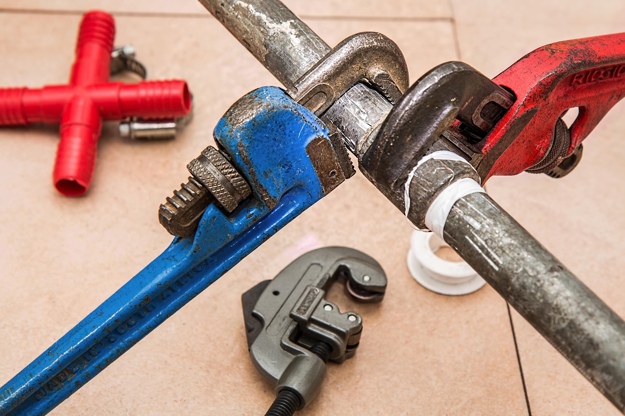 Plumbing wrenches and copper pipework.